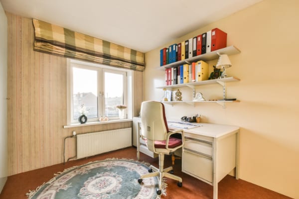a home office with a desk and a window A small home office with nice view.